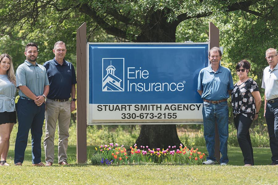 About Our Agency - Stuart Smith Agency in Front of Erie Insurance Sign
